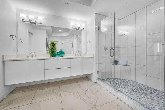 a bathroom with a shower and a sink