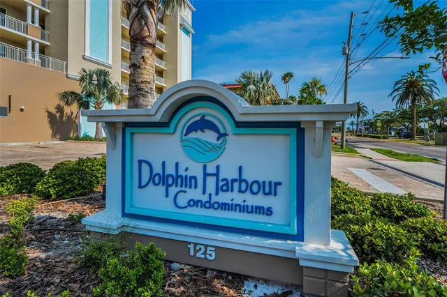 a view of sign board with flower plants