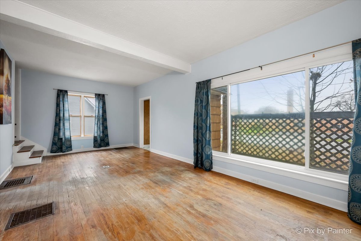 708 South 1st Street DeKalb, IL 60115 - Photo 2 of 17 a view of empty room with wooden floor