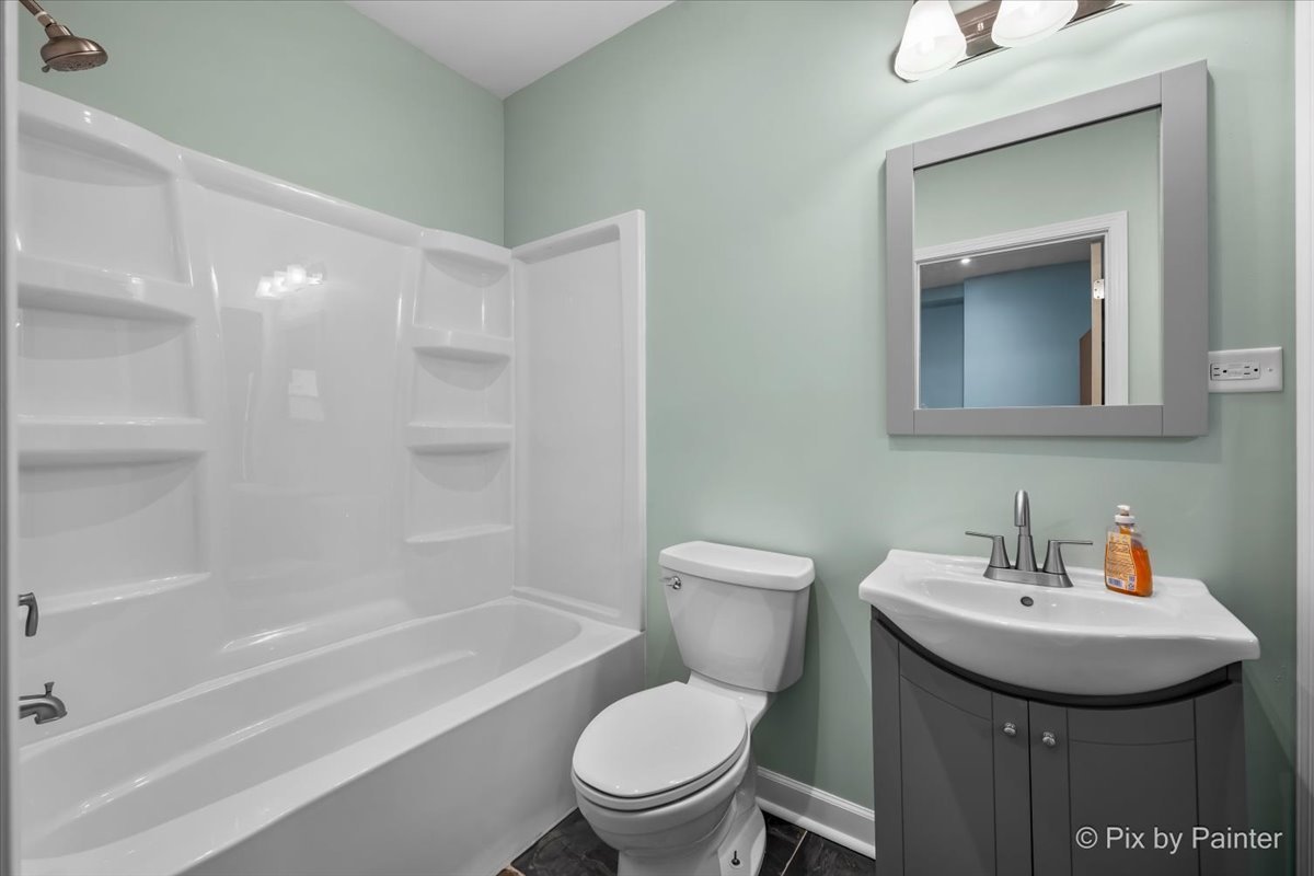 708 South 1st Street DeKalb, IL 60115 - Photo 7 of 17 a bathroom with a sink toilet and shower