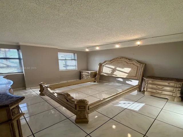 a bathroom with a granite countertop sink a toilet and mirror