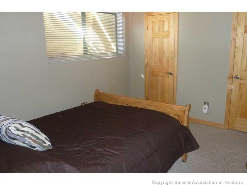 110 Evergreen Road, Unit 104B Dillon, CO 80435 - Photo 7 of 19 a bedroom with a bed and a window