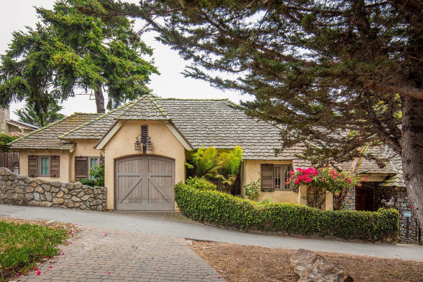 a front view of a house with a yard garage and outdoor seating