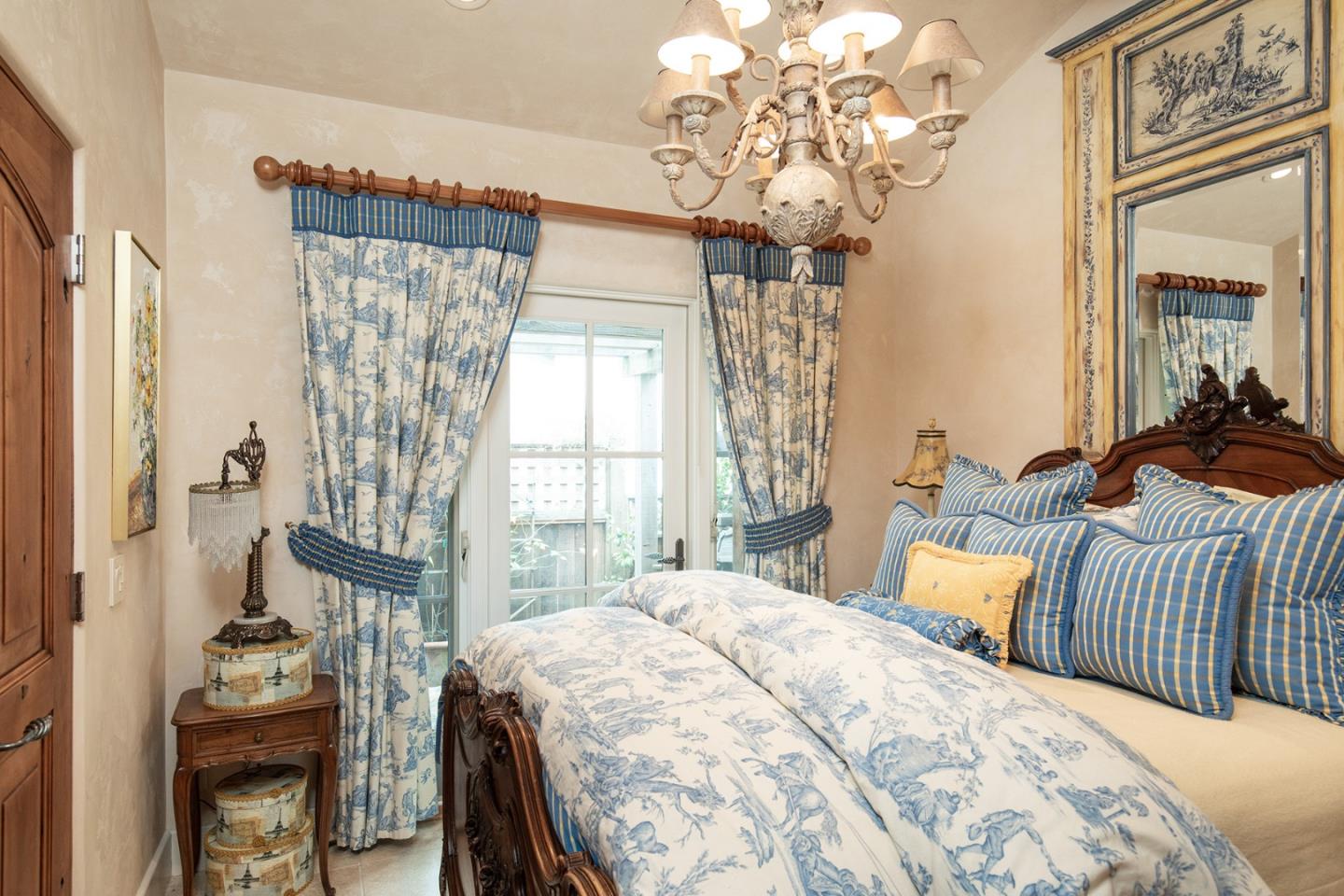 0 Southeast Se Corner Carmel, CA 93923 - Photo 15 of 21 a bedroom with a bed and a chandelier