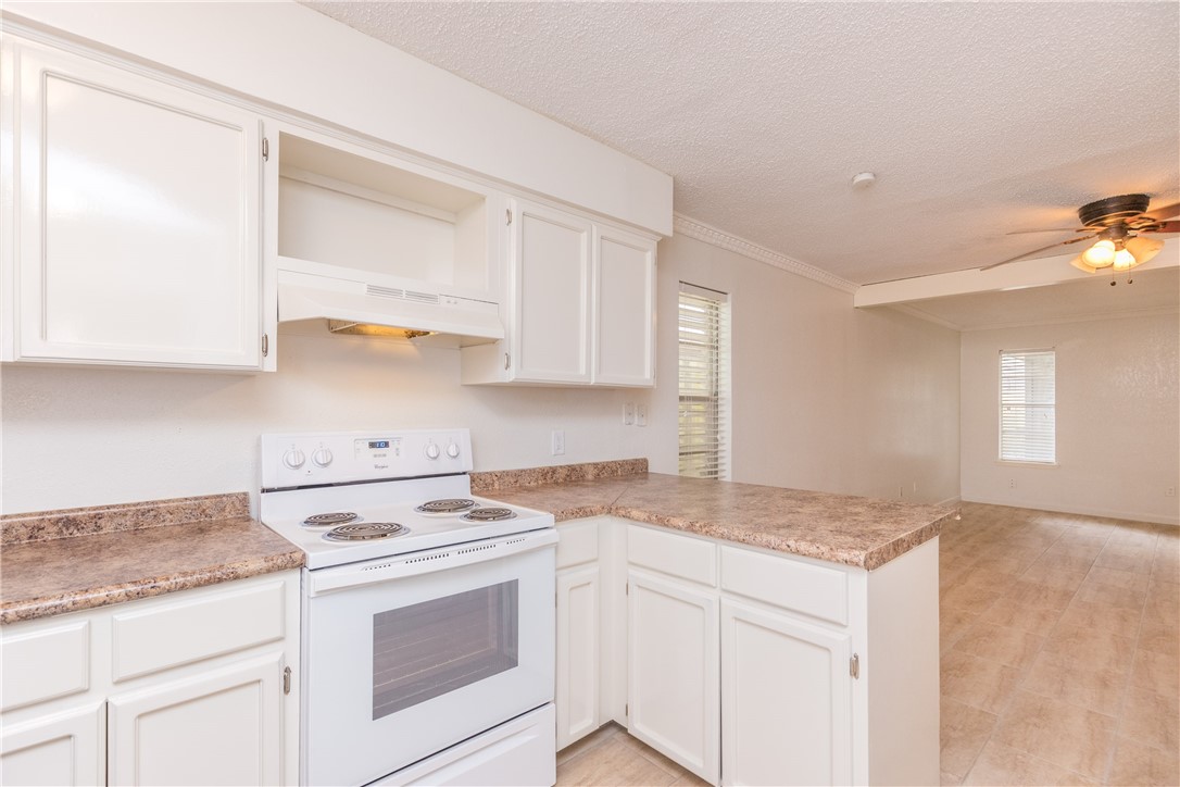 5133 Middlecoff Circle, Unit B Corpus Christi, TX 78413 - Photo 12 of 29 a kitchen with granite countertop cabinets stainless steel appliances and a sink