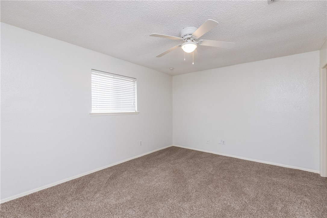 5133 Middlecoff Circle, Unit B Corpus Christi, TX 78413 - Photo 13 of 29 an empty room with a window and ceiling fan