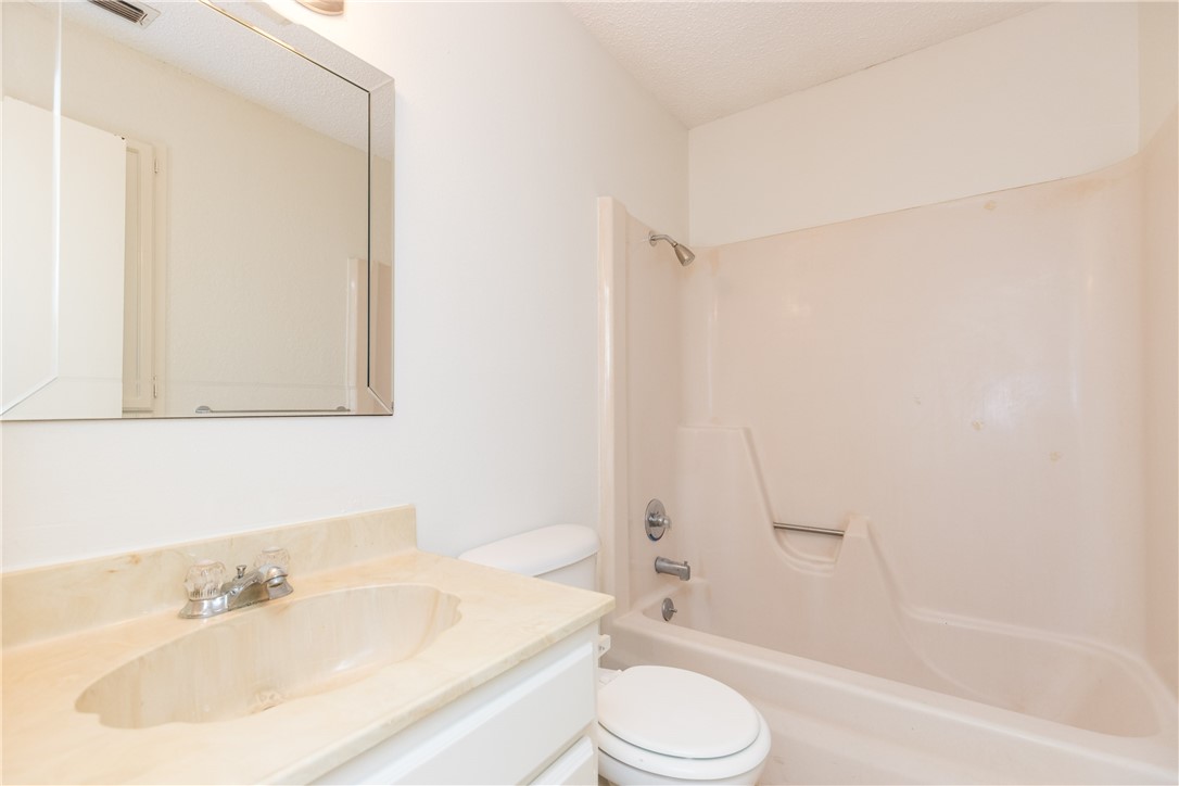 5133 Middlecoff Circle, Unit B Corpus Christi, TX 78413 - Photo 16 of 29 a bathroom with a sink toilet and shower