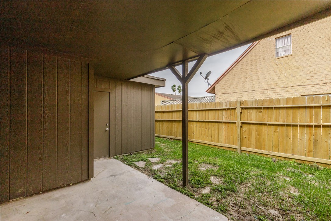 5133 Middlecoff Circle, Unit B Corpus Christi, TX 78413 - Photo 26 of 29 a backyard of a house with wooden floor