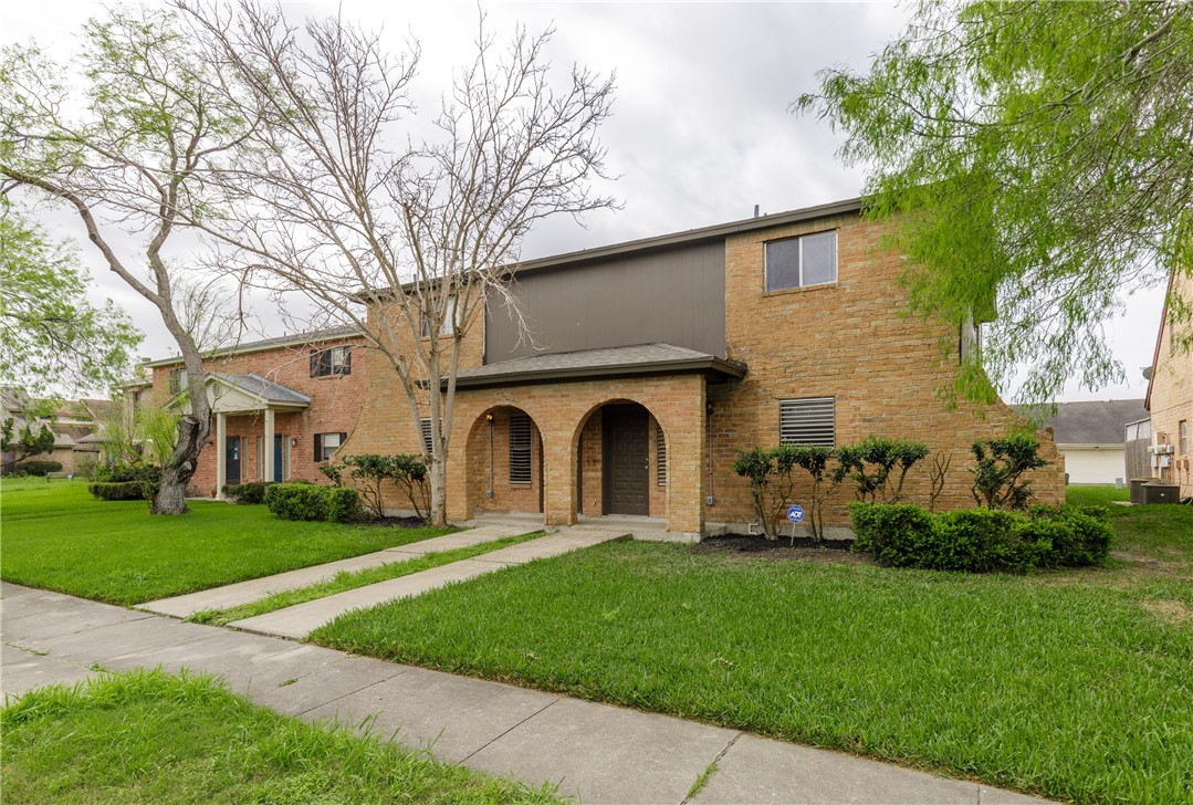 5133 Middlecoff Circle, Unit B Corpus Christi, TX 78413 - Photo 28 of 29 a front view of a house with a garden and trees