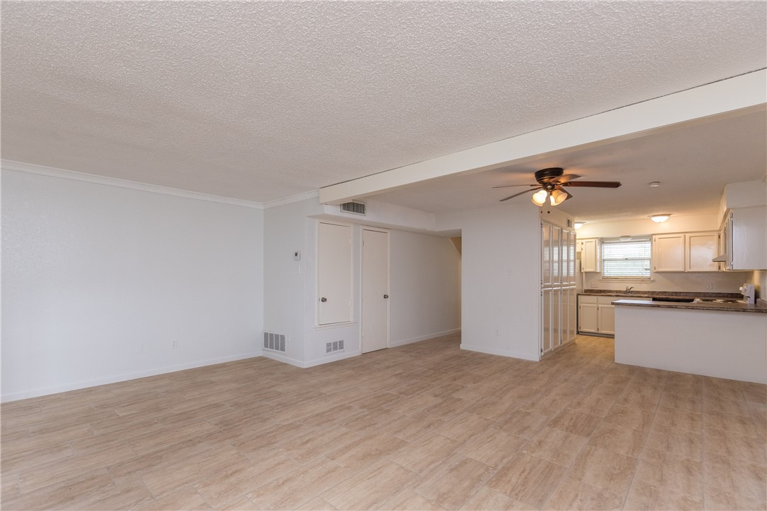 5133 Middlecoff Circle, Unit B Corpus Christi, TX 78413 - Photo 3 of 29 a view of a kitchen with a sink and dishwasher a stove top oven with wooden floor