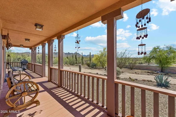 a roof deck with a dining table and chairs with wooden floor