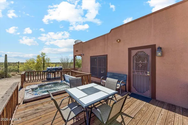 a backyard of a house with table and chairs