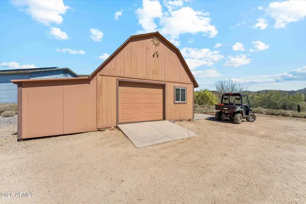 a view of a dry yard with mountains in the background