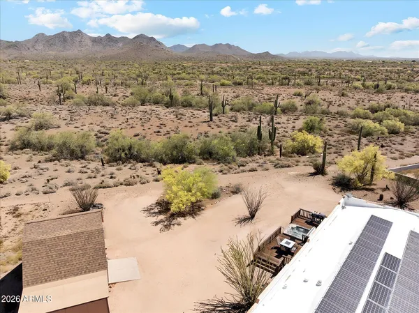 a view of a dry yard with mountains in the background