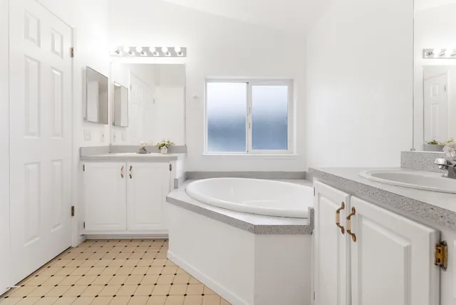 a bathroom with a sink a toilet a mirror and vanity