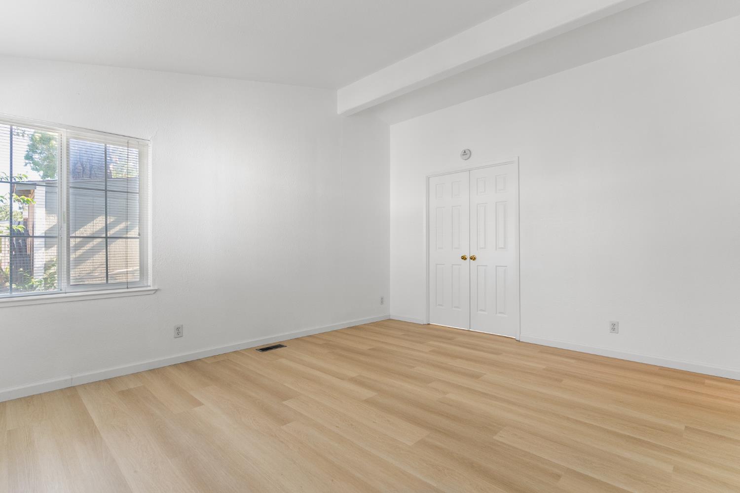 200 Ford Road, Unit 227 San Jose, CA 95138 - Photo 15 of 37 a view of an empty room with wooden floor and a window