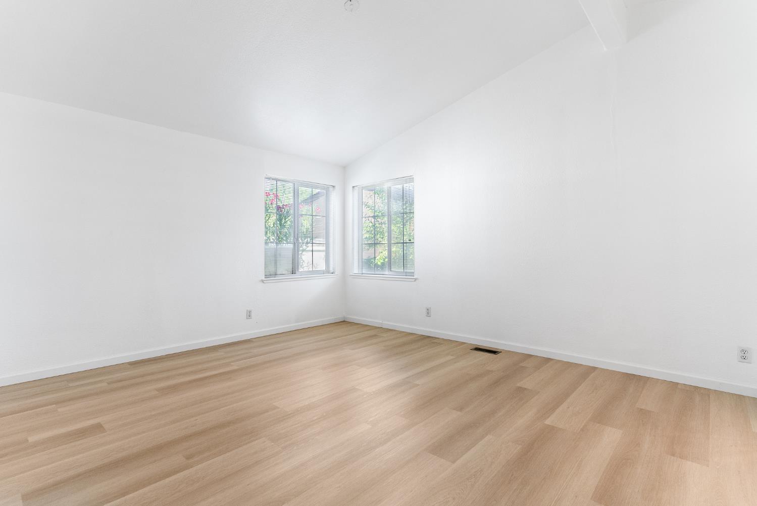200 Ford Road, Unit 227 San Jose, CA 95138 - Photo 16 of 37 an empty room with wooden floor and windows
