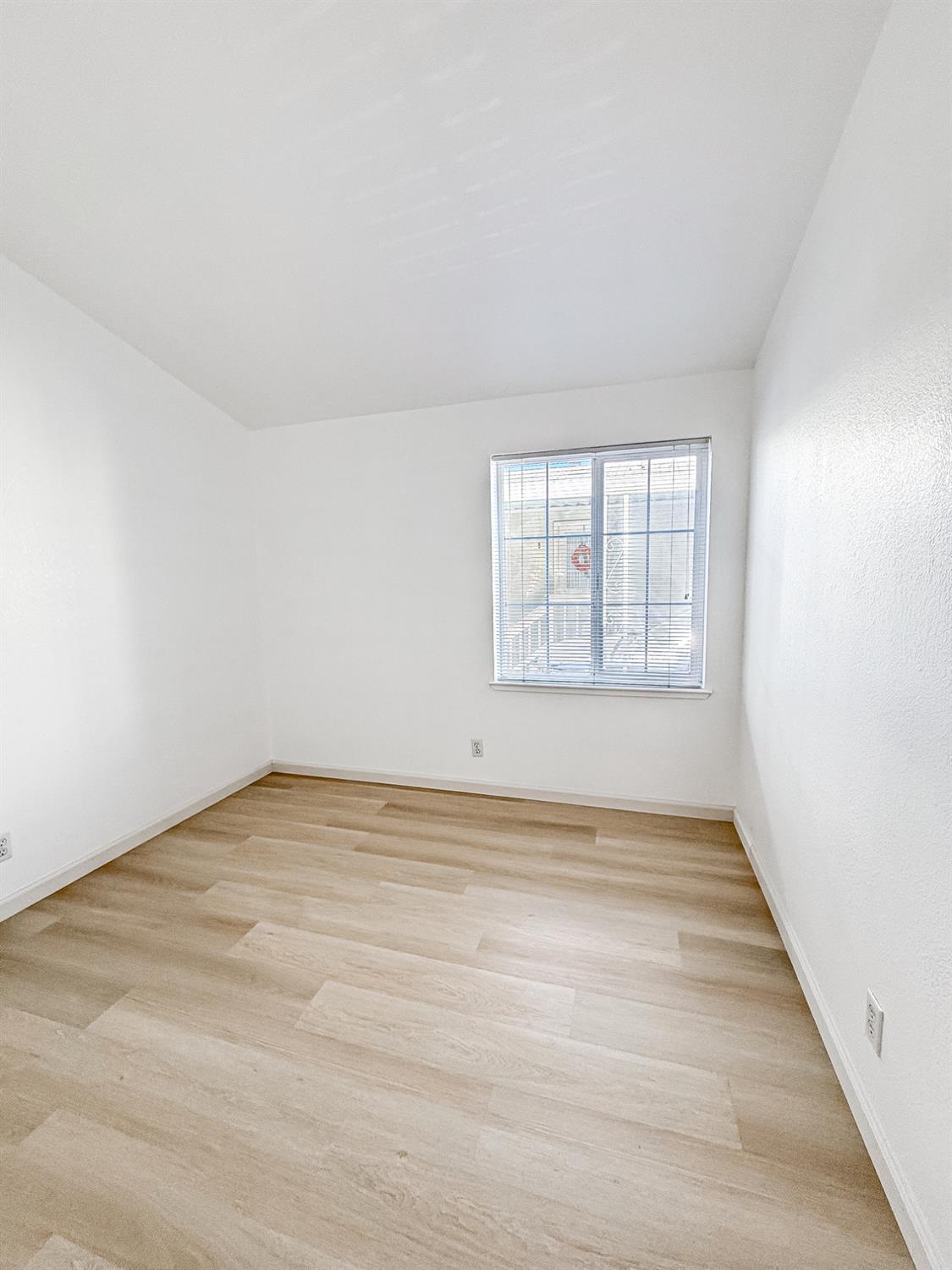 200 Ford Road, Unit 227 San Jose, CA 95138 - Photo 24 of 37 an empty room with wooden floor and windows