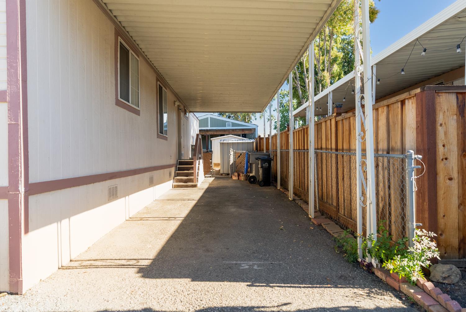 200 Ford Road, Unit 227 San Jose, CA 95138 - Photo 32 of 37 a view of a patio with table and chairs with wooden fence