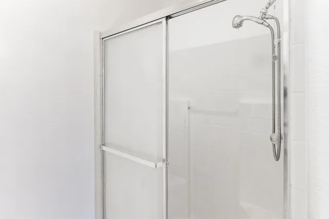a bathroom with a glass shower door