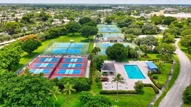 a view of a swimming pool with a lot of trees in the background