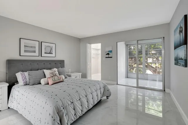 a bedroom with a large bed and a glass door