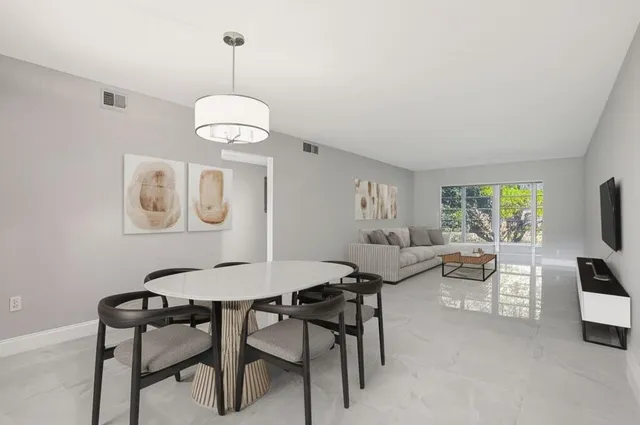 a view of a dining room with furniture wooden floor and chandelier