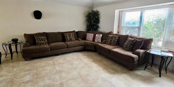 a living room with furniture and a large window