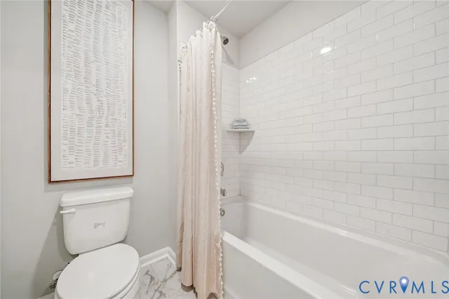 a bathroom with a toilet and a bathtub