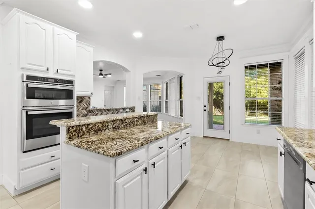 a kitchen with stainless steel appliances granite countertop a stove and a sink