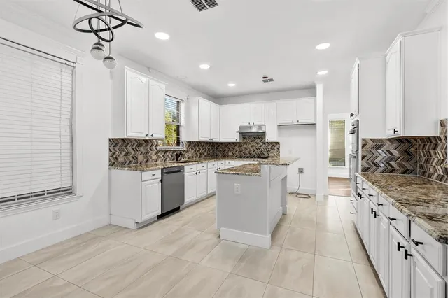 a kitchen with a refrigerator a sink and cabinets