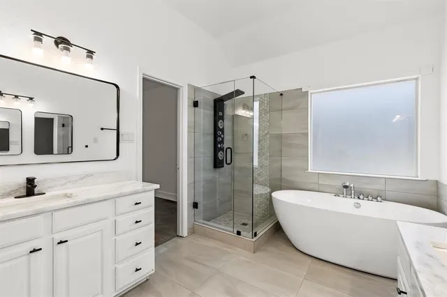a bathroom with a double vanity sink mirror double and shower