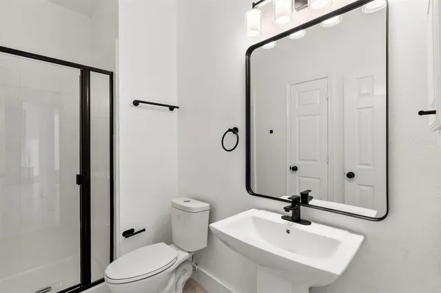 a bathroom with a toilet a sink and a mirror