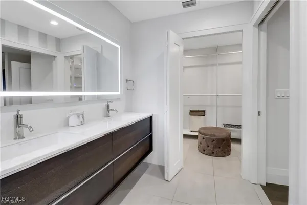 a bathroom with a double vanity sink a and mirror