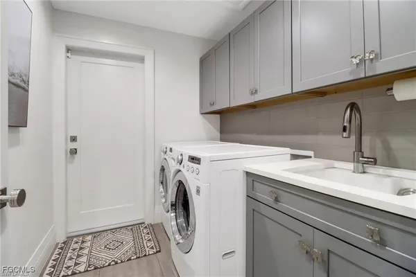 a utility room with sink dryer and washer