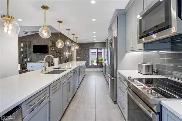 a kitchen with stove top oven and cabinets