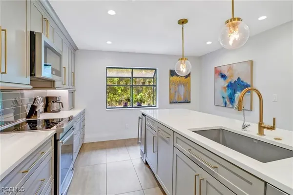 a kitchen that has a lot of cabinets and a wooden floor