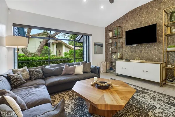 a living room with furniture and a flat screen tv