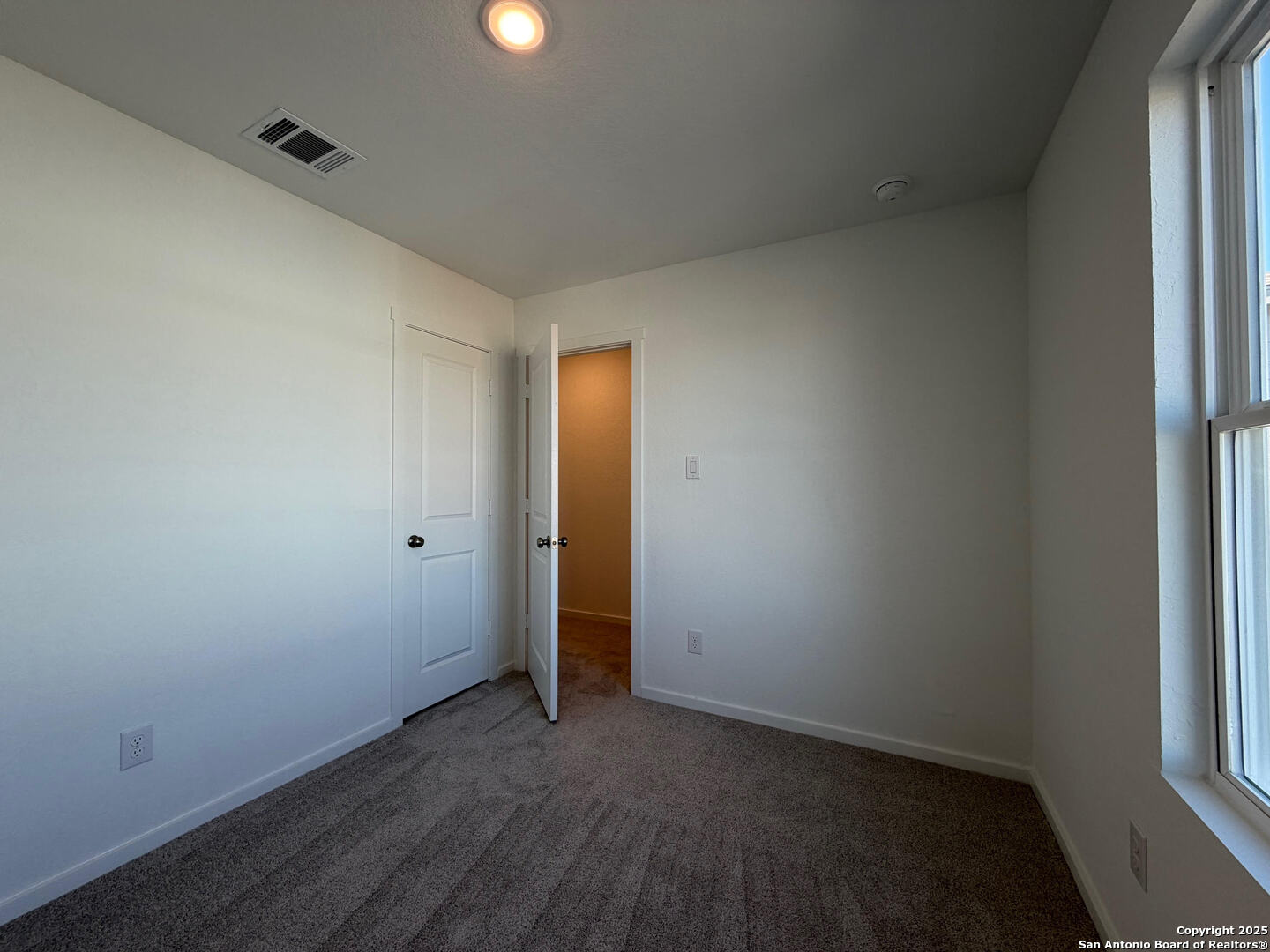 11910 Bluebell Ridge Converse, TX 78109 - Photo 12 of 15 an empty room with wooden floor and windows