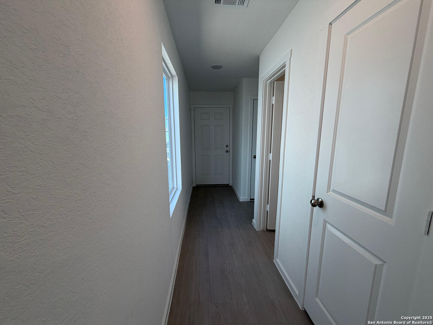 11910 Bluebell Ridge Converse, TX 78109 - Photo 6 of 15 a view of a hallway with wooden floor and closet area