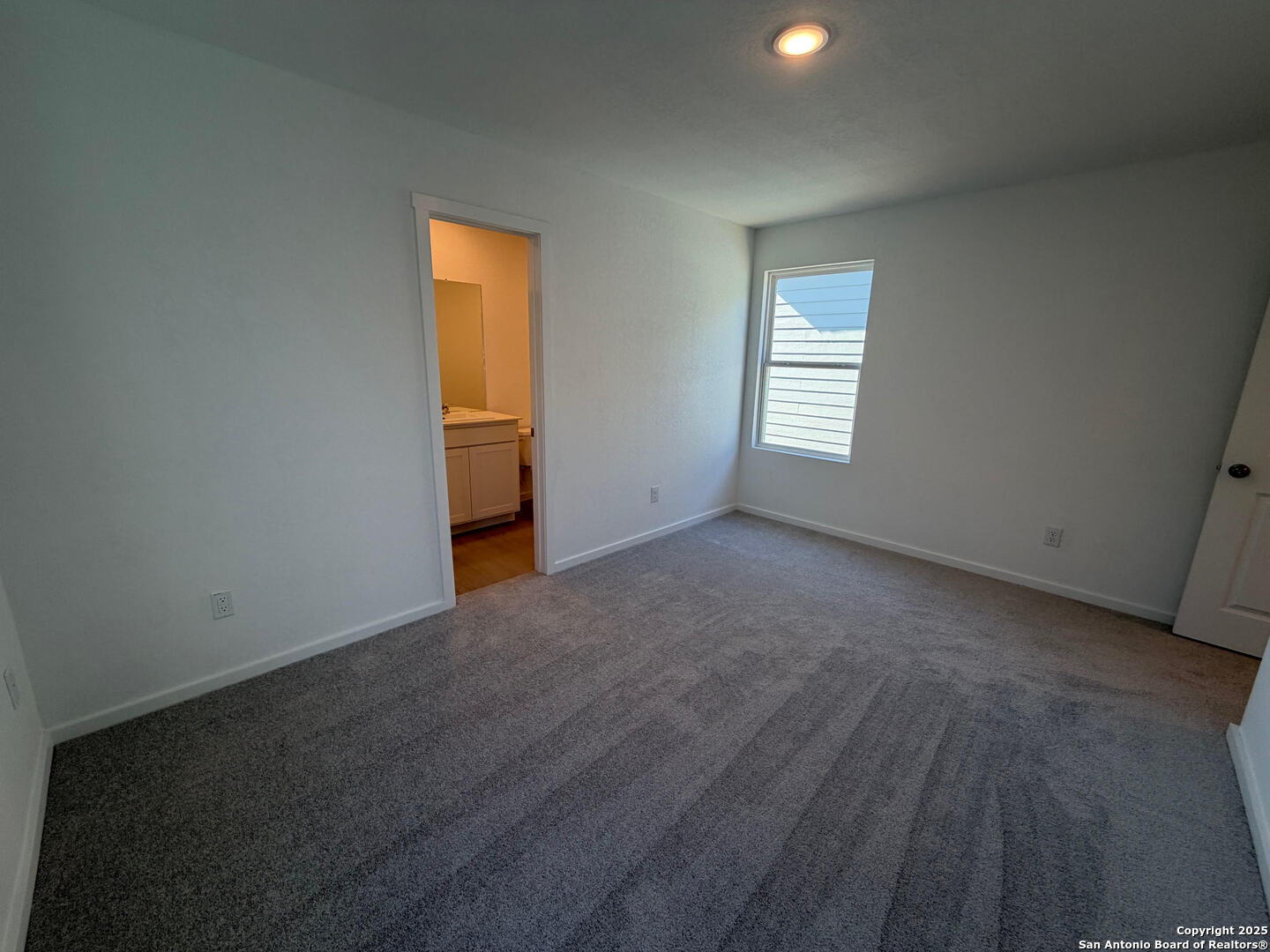 11910 Bluebell Ridge Converse, TX 78109 - Photo 8 of 15 a view of an empty room with wooden floor and a window