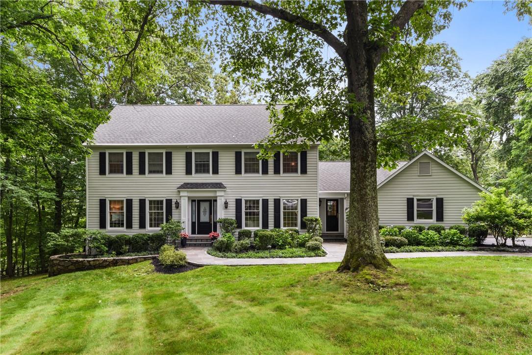 6 Crest Court Armonk, NY 10504 - Photo 1 of 1 a front view of a house with a yard table and chairs