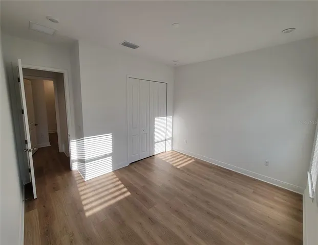 a view of an empty room and wooden floor
