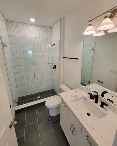 a large kitchen with stainless steel appliances granite countertop a refrigerator and a sink