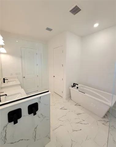 a bathroom with a sink toilet and tub