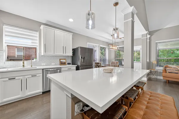 a large kitchen with stainless steel appliances lots of counter top space