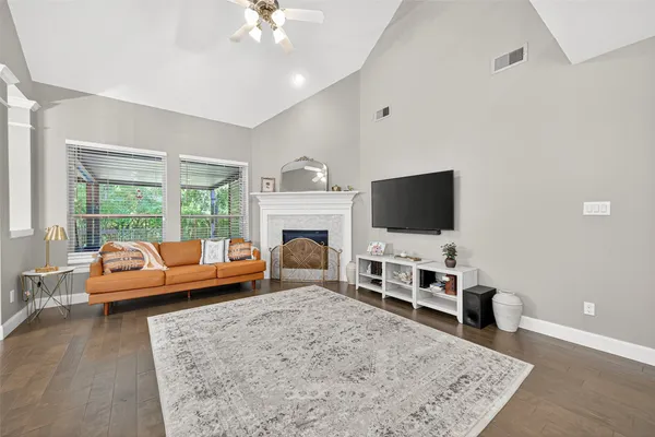 a kitchen with stainless steel appliances granite countertop white cabinets a sink and a stove
