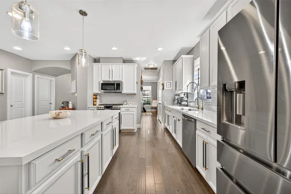 a kitchen with stainless steel appliances a sink stove and microwave