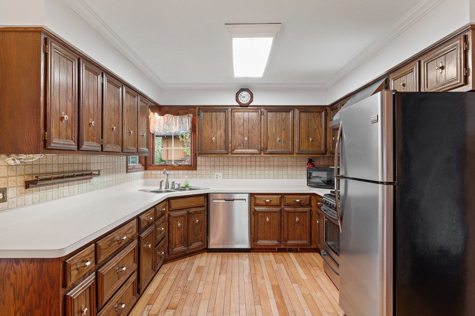 2929 East Danne Road Crete, IL 60417 - Photo 14 of 56 a kitchen with stainless steel appliances granite countertop a refrigerator a sink dishwasher a stove and white countertops with wooden floor