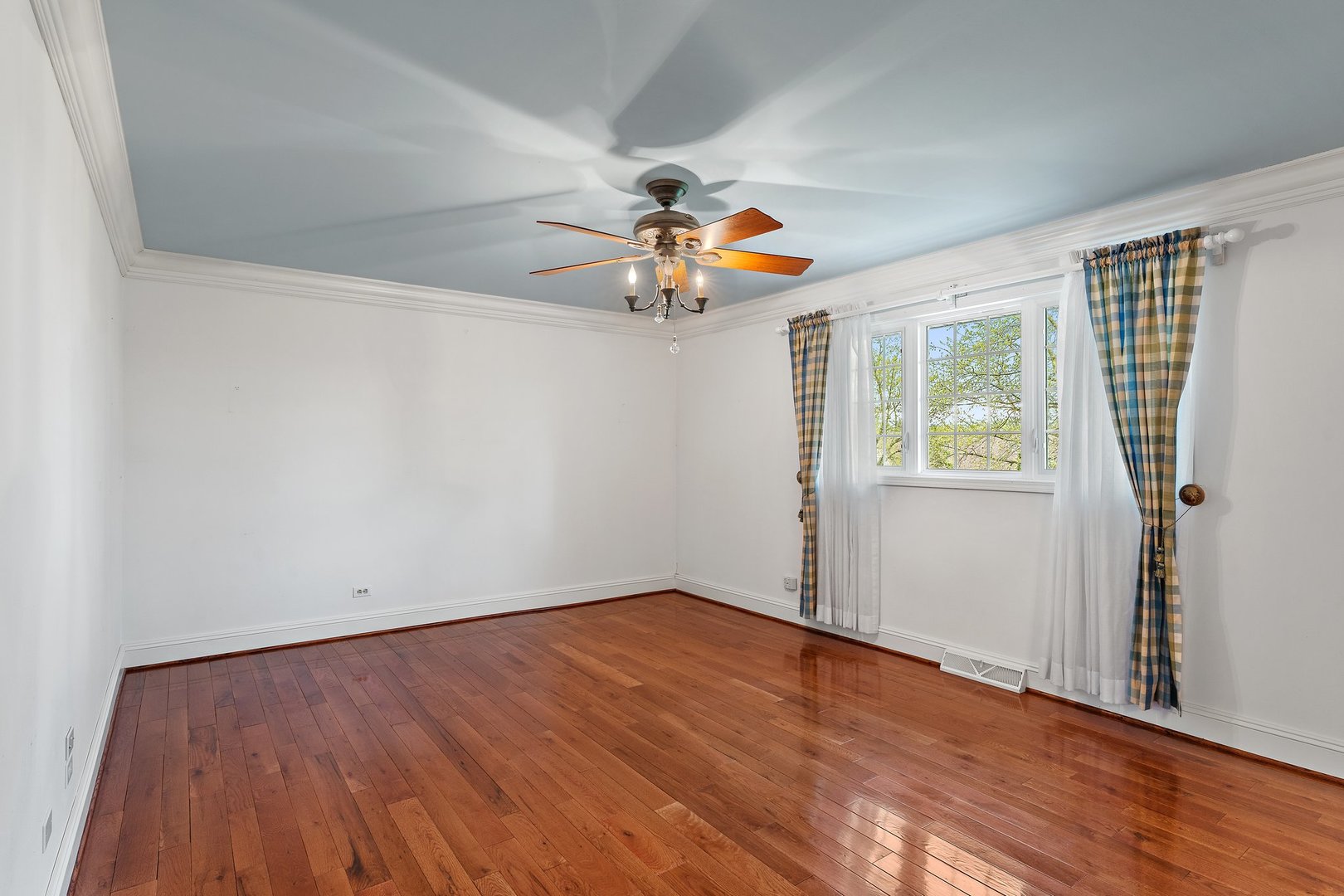 2929 East Danne Road Crete, IL 60417 - Photo 20 of 56 an empty room with wooden floor chandelier fan and windows